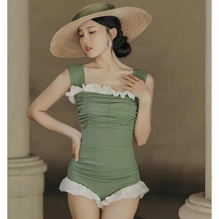 Korean-style high-waist one-piece swimsuit in black, pink, or green on a model