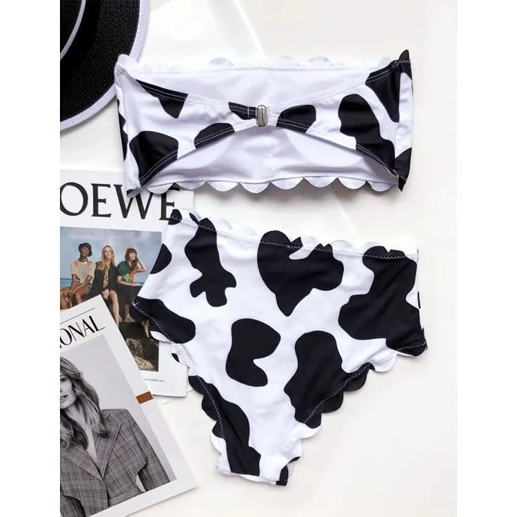 Black and white cow print wrapped breast bikini set on a model, nylon fabric, black and white animal pattern, adjustable wrap front top