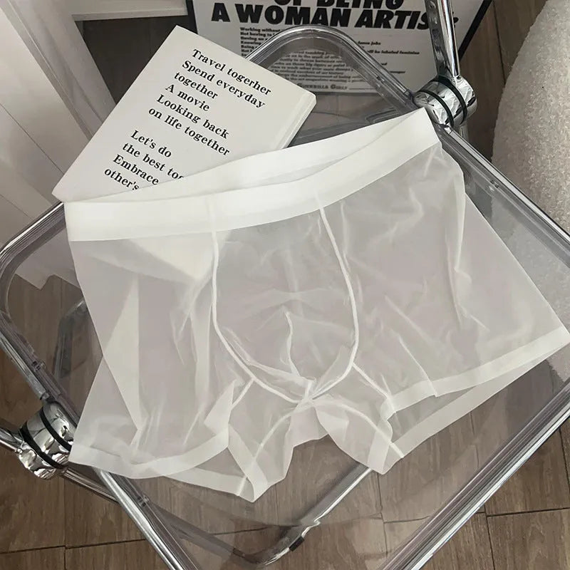 Man wearing thin grey seamless nylon boxer shorts with a mid-waist design.