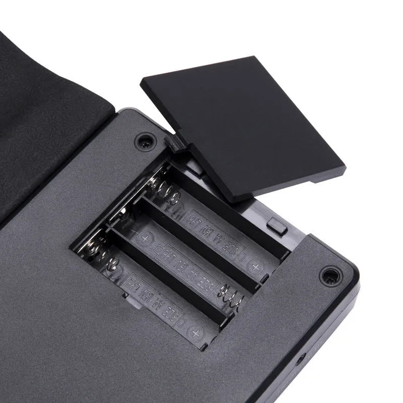 Portable folding electronic keyboard with 49 silicone rubber keys and built-in speaker in gloss black