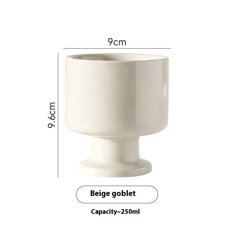 Irregularly shaped hand-pinched ceramic mug in a solid colour, shown on a plain background.
