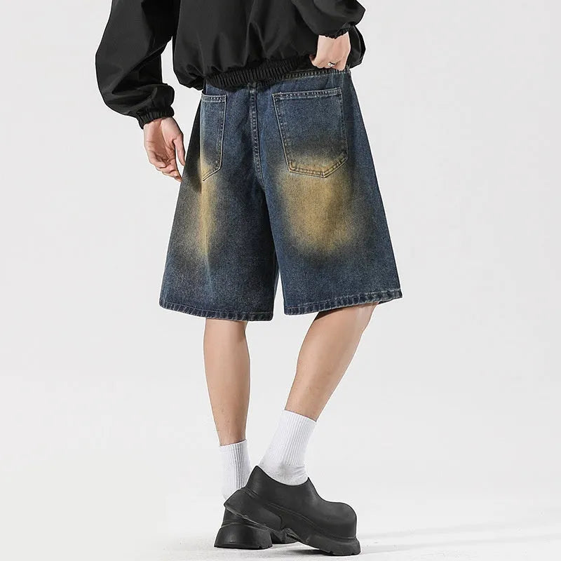 Loose-fit ripped jeans in retro blue denim, shown on a model, highlighting the baggy fit and distressed details.