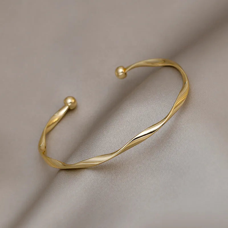 Gold twisted alloy bracelet with geometric Korean style design and 6.2cm inner ring diameter