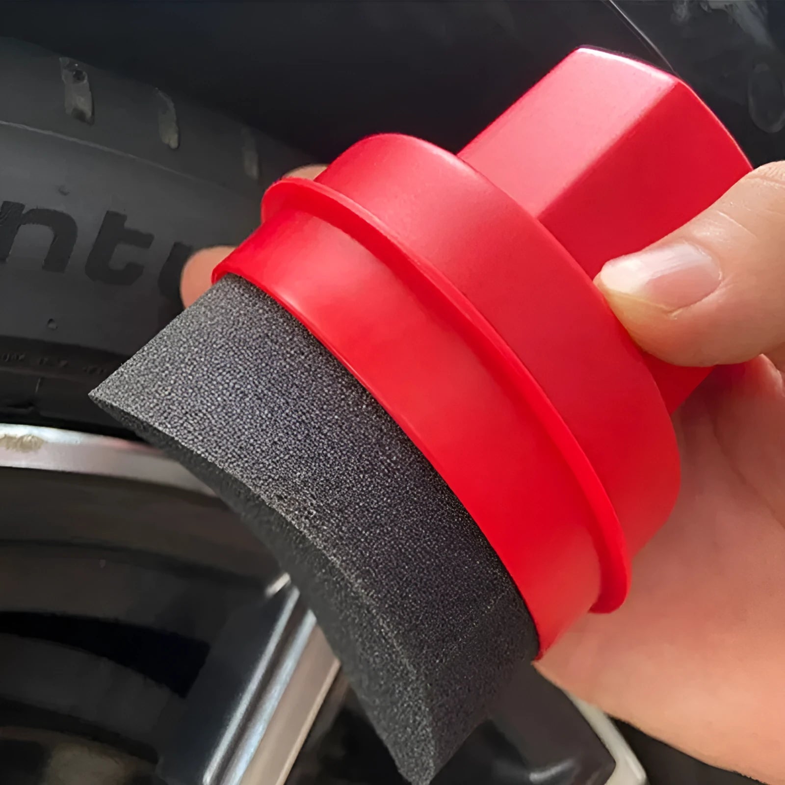 Black car tyre polishing sponge brush with high-density foam head and a white protective lid on a tyre.