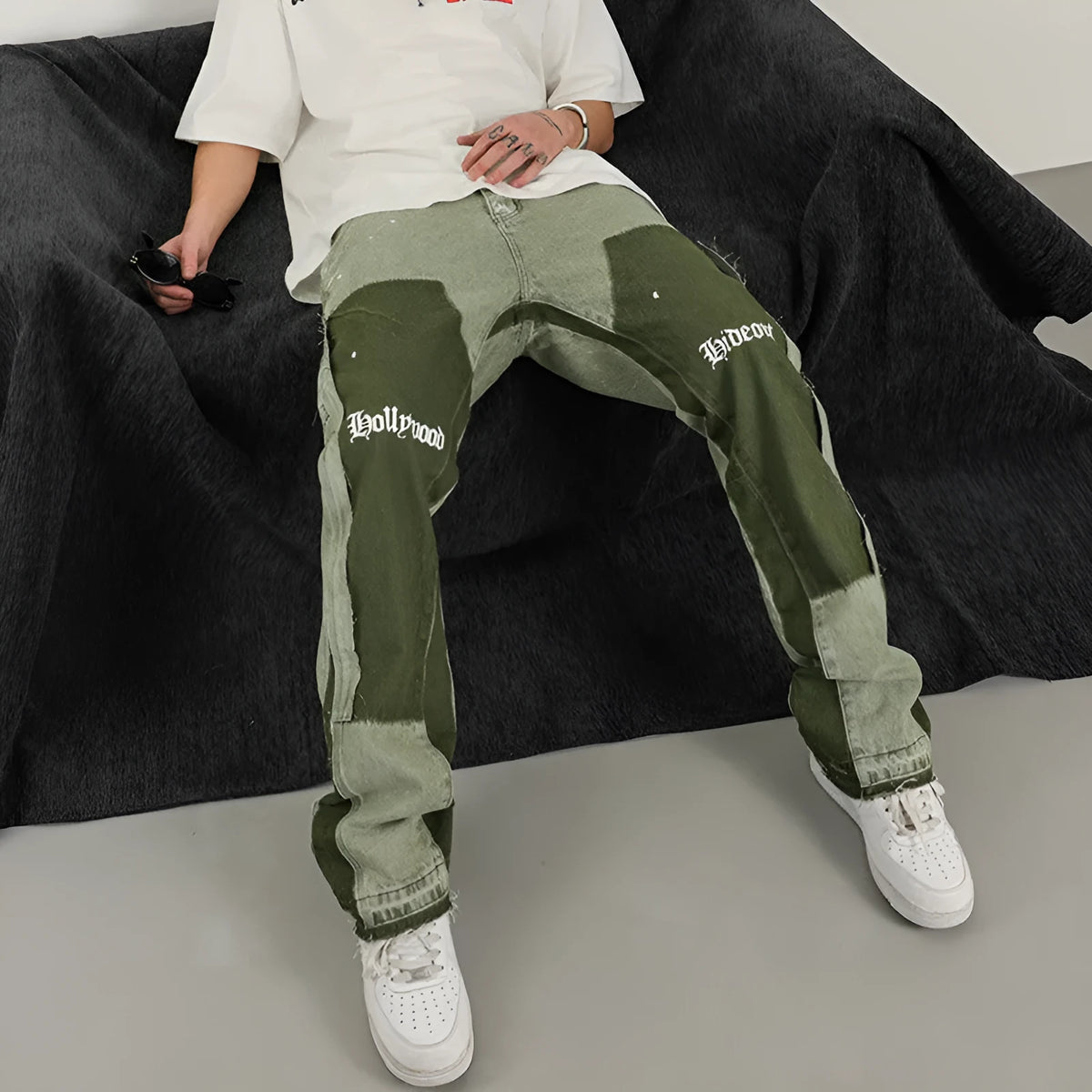 Men's heavy wash flared denim trousers in black green with multi-pocket and raw edge detailing