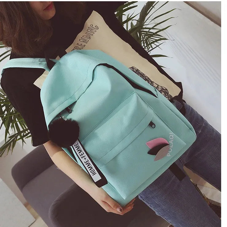 College style canvas backpack in green with leaf pattern, showing 40cm height and organisational compartments