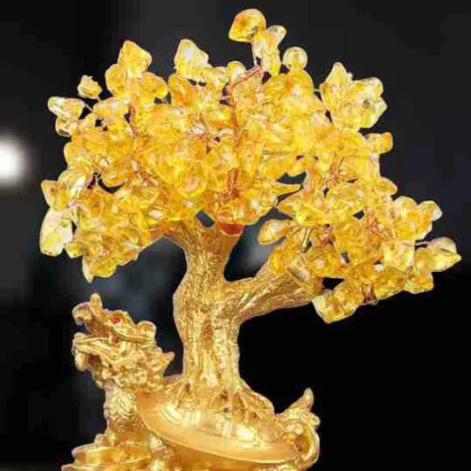 Citrine-coloured resin Feng Shui ornament of a small water turtle money tree on a white background.