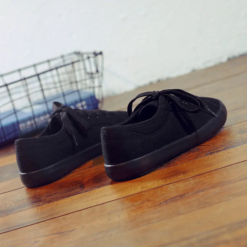 All black Korean-style women's canvas flat shoes with lace-up front and rubber sole