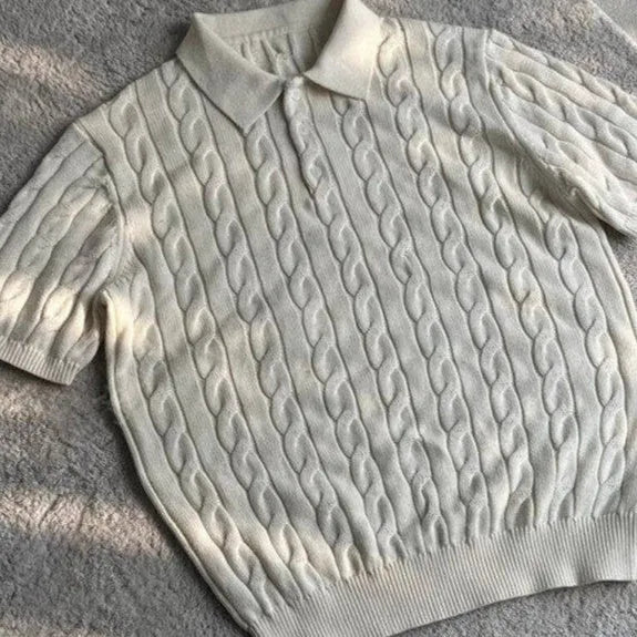 Man wearing a grey knitted short-sleeve T-shirt made from twisted combed cotton blend.