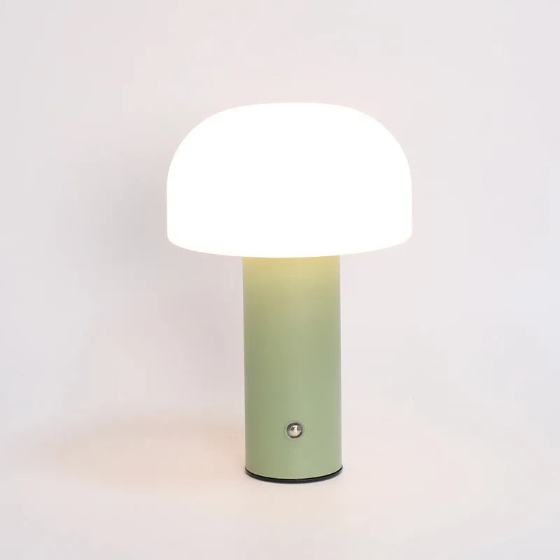 White plastic USB table lamp with integrated charging port on a wooden desk.