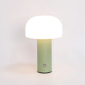 White plastic USB table lamp with integrated charging port on a wooden desk.