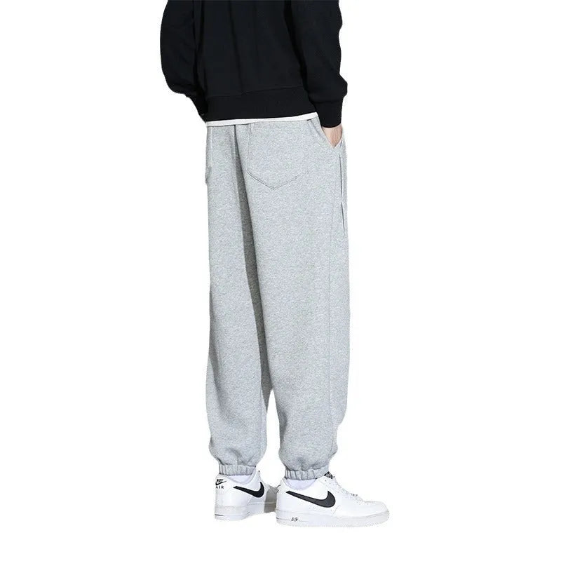 Men's loose fit grey sports trousers with drawstring waist and cotton-polyester blend fabric