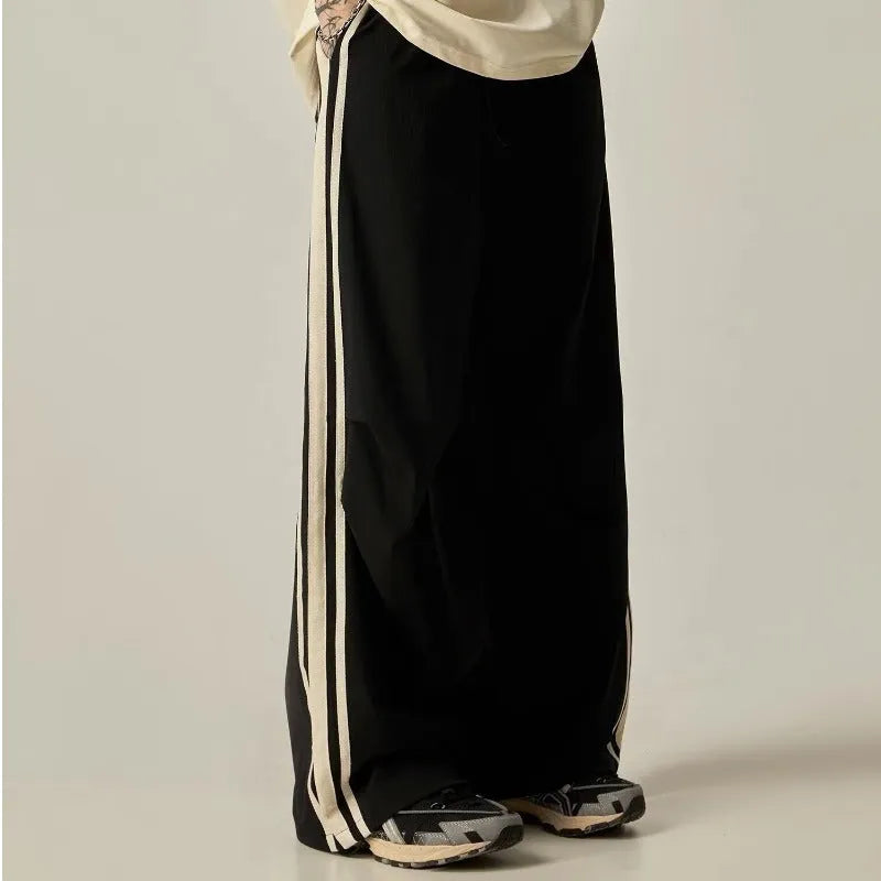 Black men's high-waisted wide-leg casual trousers laid flat.