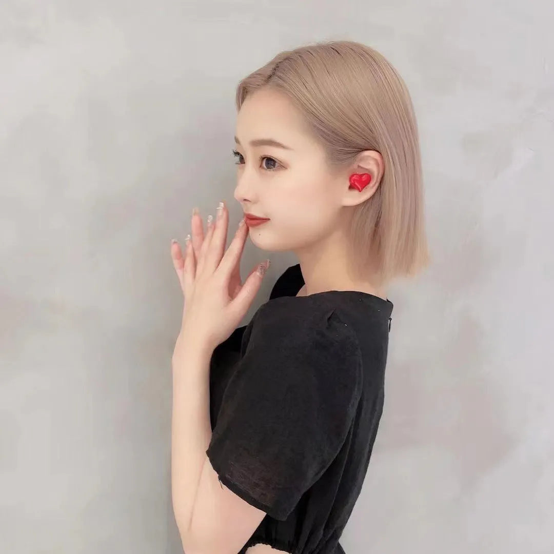Heart-shaped wireless Bluetooth headphones in Chinese red colour with charging cable