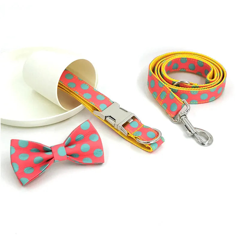 Yellow polka dot dog collar with attached lead rope and fabric bow decoration