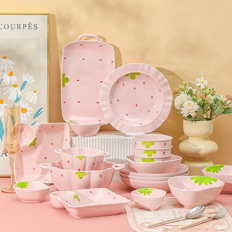 Creative strawberry-themed porcelain dinnerware set with fish plate, flower bowls, and straw hat plate.
