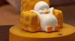 Cute yellow duck plastic night light table lamp with USB cable and gift box on a modern desk