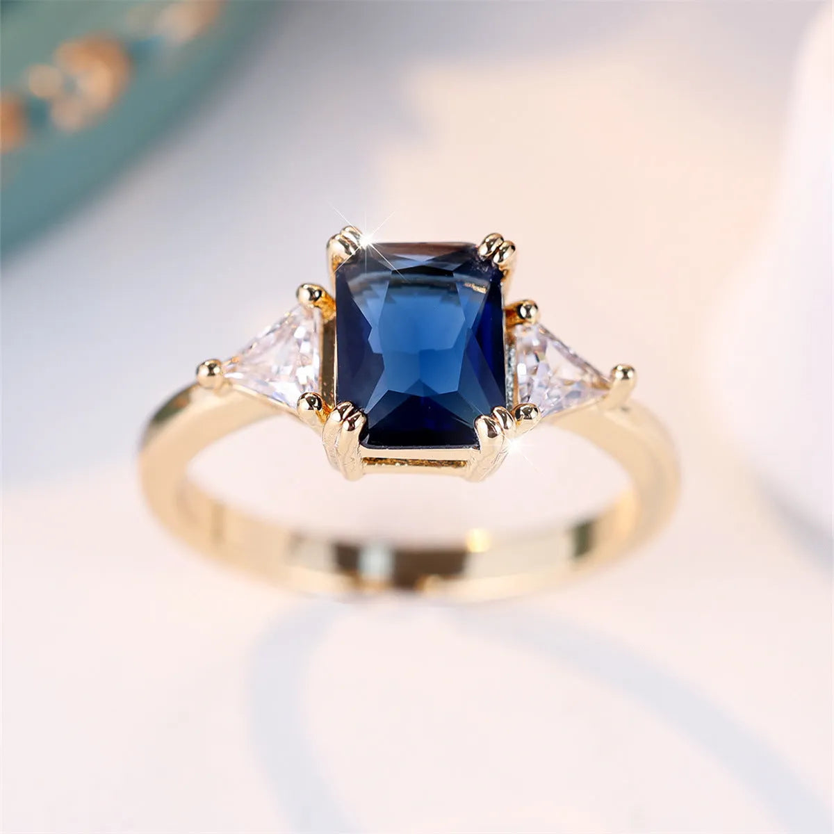 Rectangular gold sapphire blue copper ring for women showing geometric design