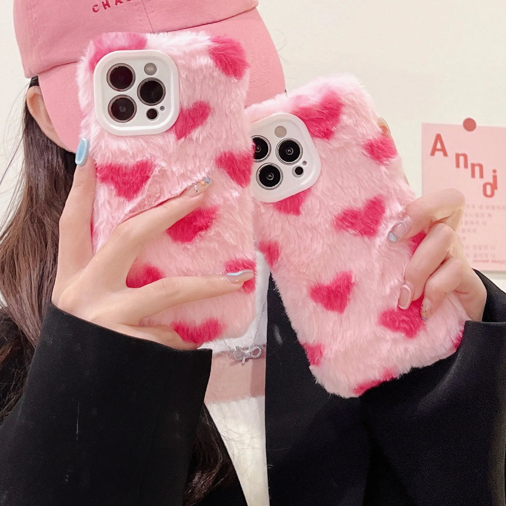Pink silicone iPhone case with cartoon Love Plush design, shown fitted on a mobile phone.