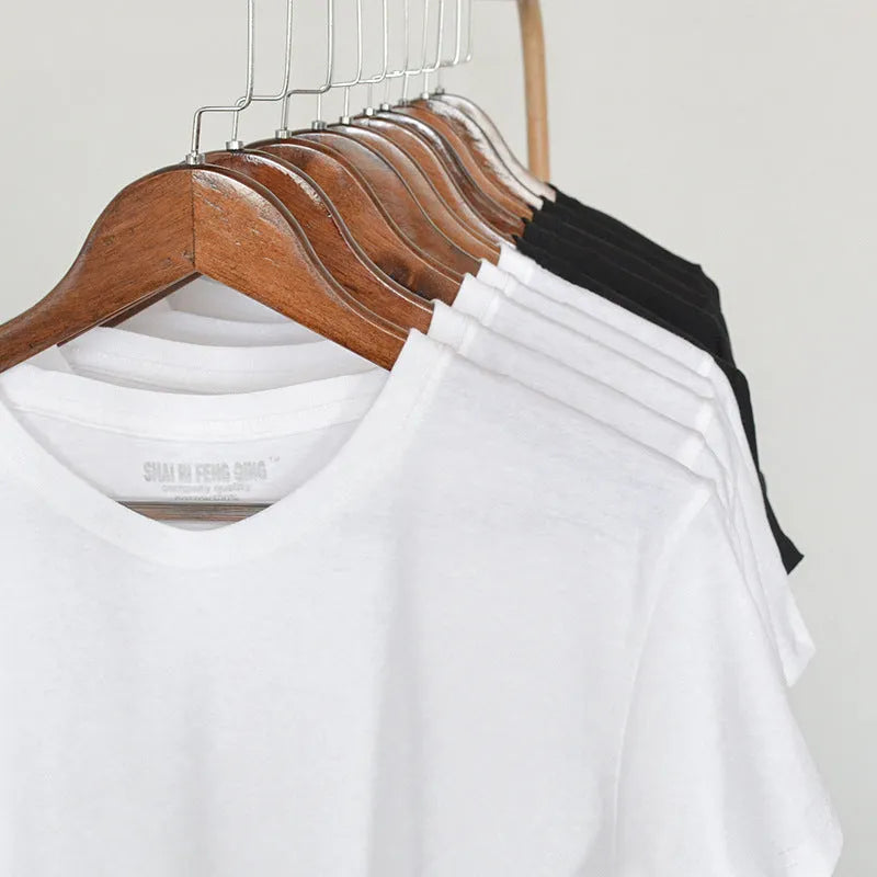 Men's solid colour round neck cotton t-shirt on a hanger, showing the short sleeve and blank front design.