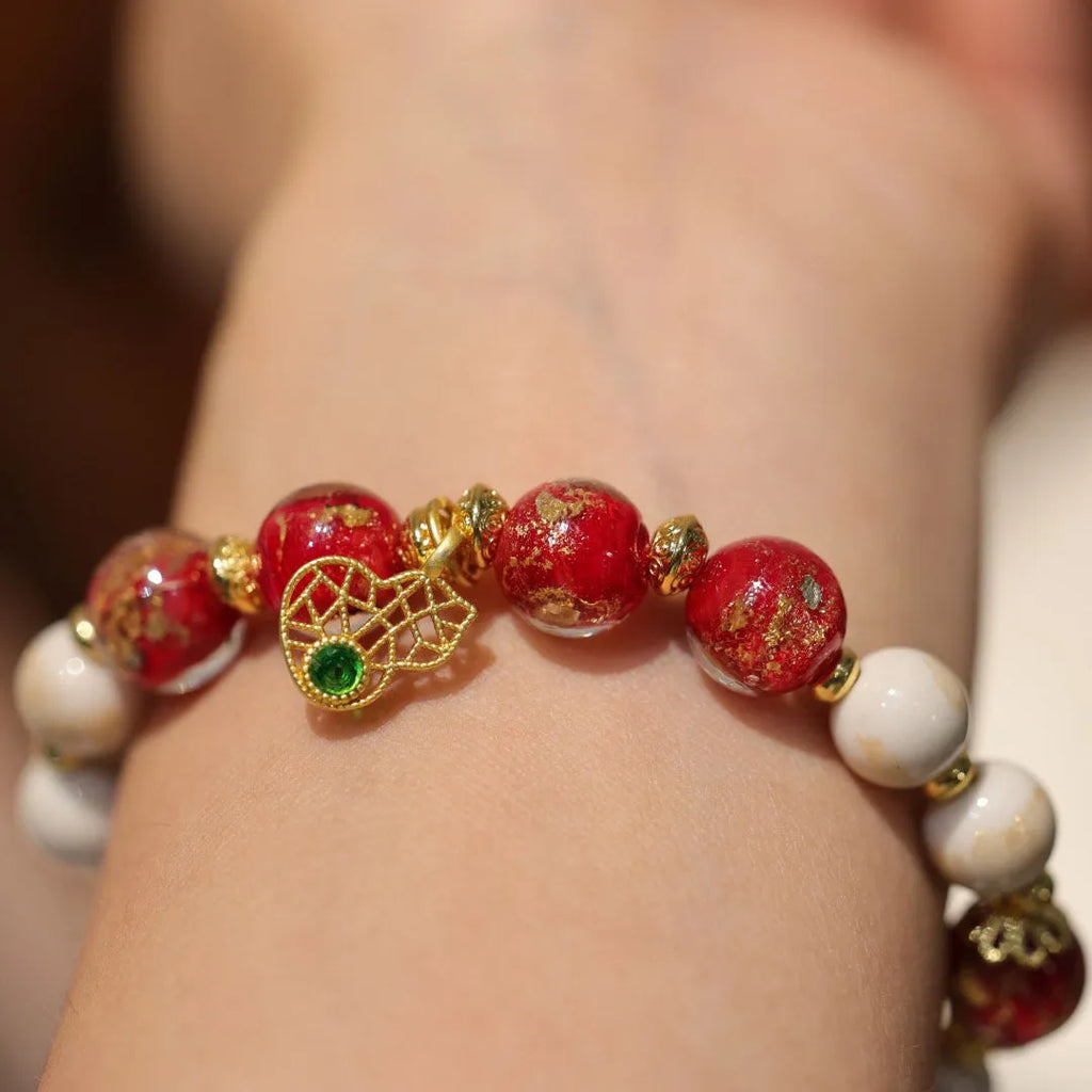 Handmade ethnic style coloured glaze bracelet with gold foil detailing and porcelain hanging gourd design