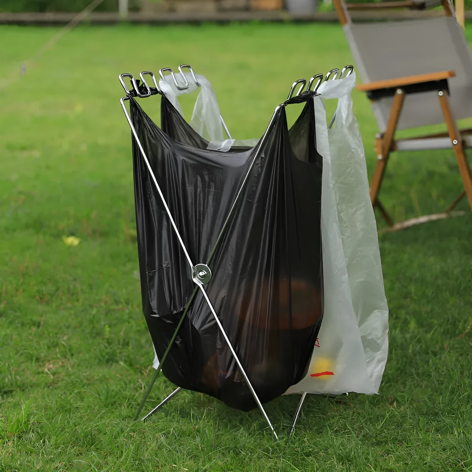 Stainless steel folding garbage bag bracket in collapsed position showing silver finish
