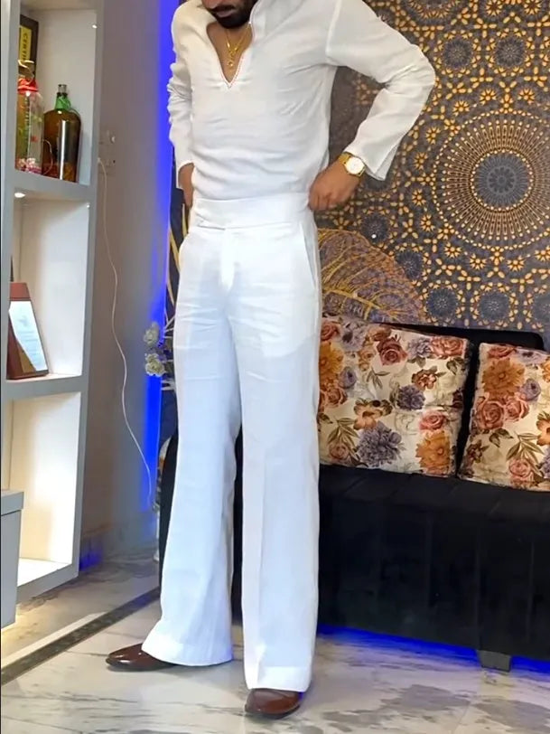 White three-piece outfit comprising V-neck shirt, sleeveless vest and trousers on hanger