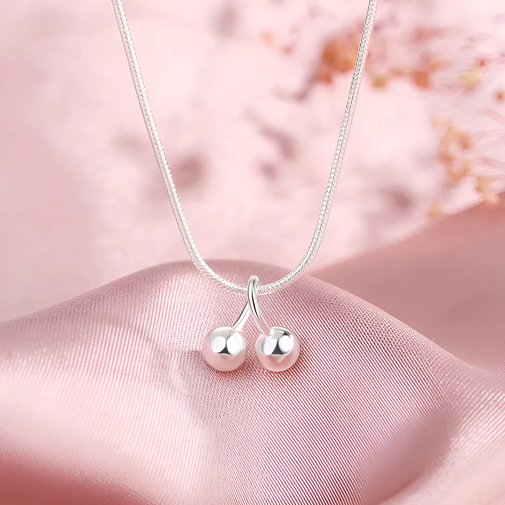 Silver cherry pendant necklace on a snake bones chain, adjustable from 21cm to 50cm length.