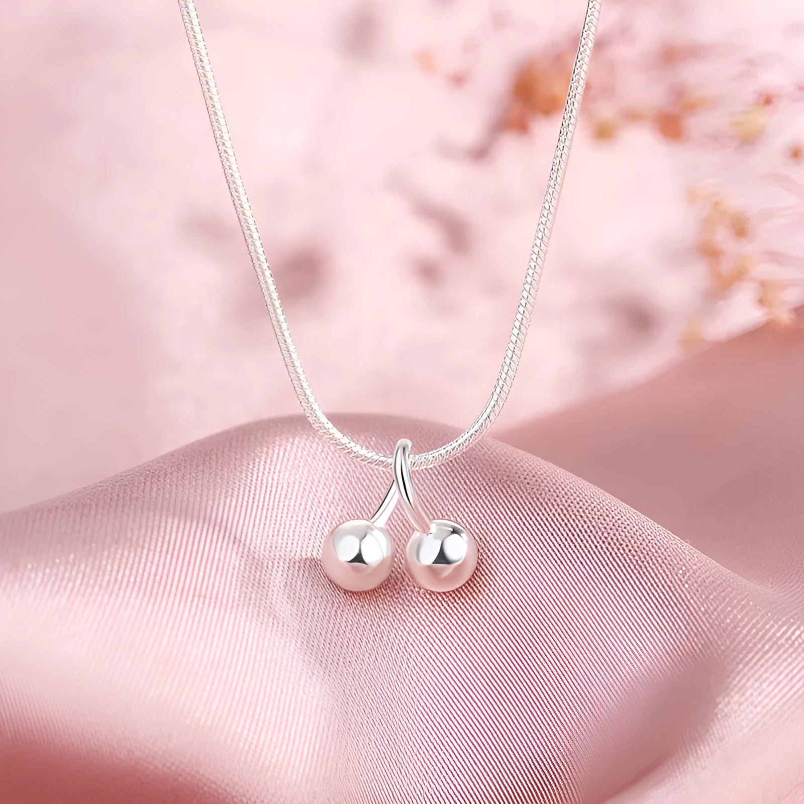 Silver cherry pendant necklace on a snake bones chain, adjustable from 21cm to 50cm length.