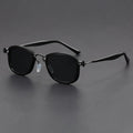 Retro square sunglasses with metal frame and tinted AC lenses in a two-tone colour option on a wooden surface.