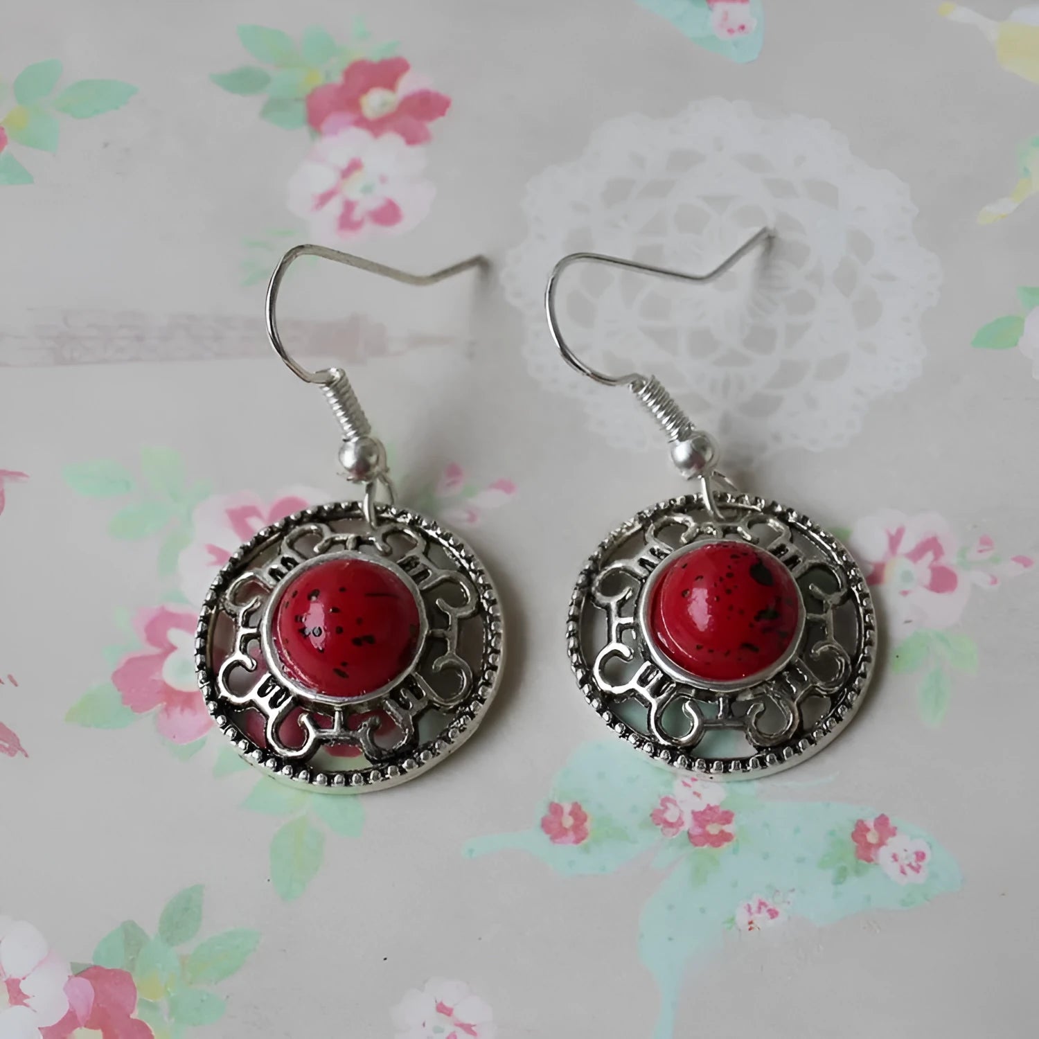 Handmade Miao silver and turquoise earrings with geometric flower disk and ethnic patterns.