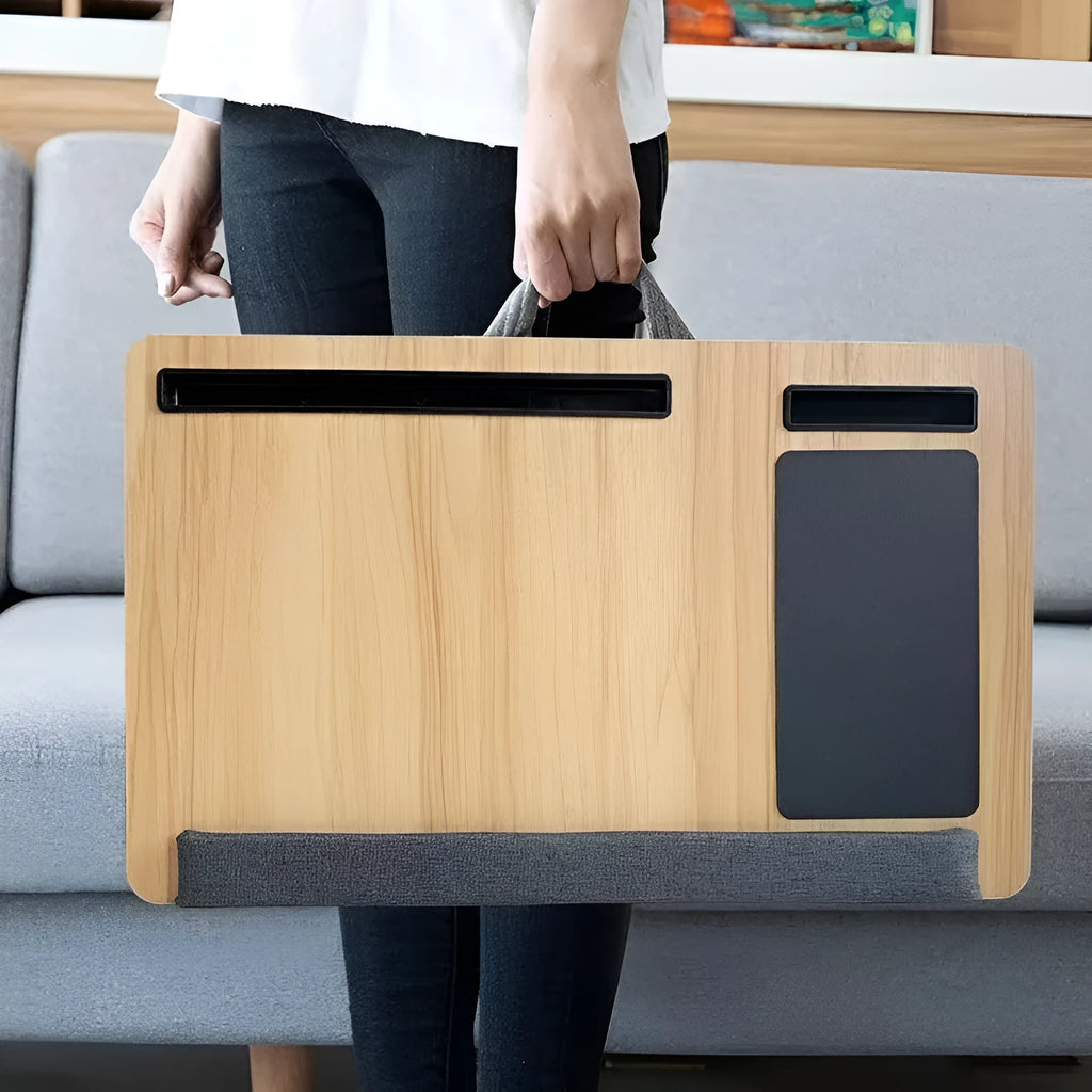 Foldable laptop desk in black walnut colour on a bed, showing open leg supports.