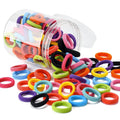 100 multicolour seamless cotton baby hair ties in a jar, shown next to a toddler's ponytail.