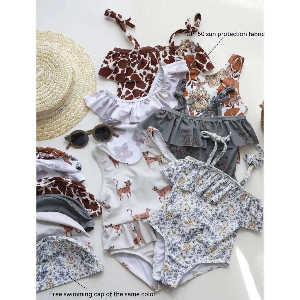 Girls' high elastic one-piece swimsuit in a selection of prints including brown stripes, leopard, and floral patterns.