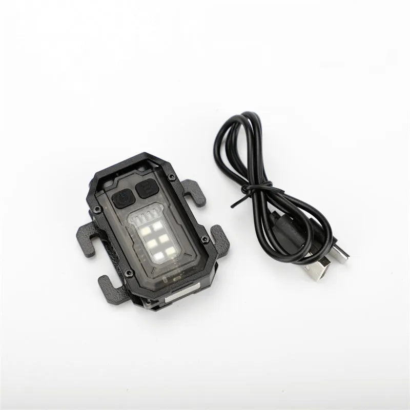 Mini tactical flashlight with USB charging cable showing dual lighting modes and backpack mount attachment point