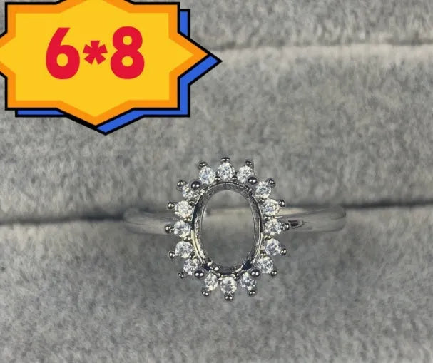 Oval denier open mouth ring with 6x8 main stone and five-pointed star design