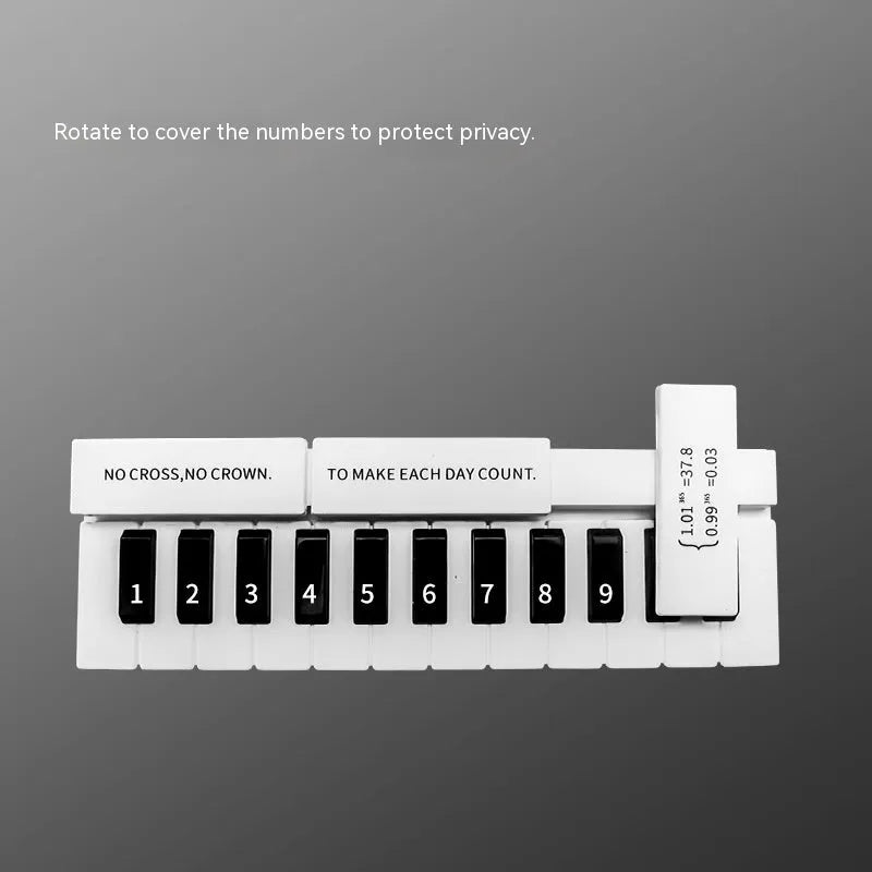 Black and white plastic piano-shaped temporary parking sign for car dashboards.
