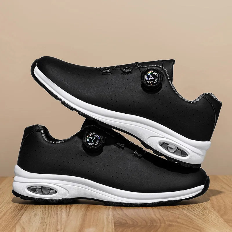 Black and white low-top tennis shoes with mesh upper and composite sole.