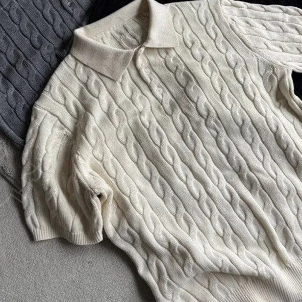 Man wearing a grey knitted short-sleeve T-shirt made from twisted combed cotton blend.