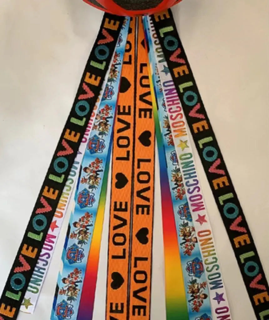 A decorative ribbon streamer for attaching to a child's roller skate or ski helmet, shown in a selection of colours.