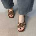 Women's light brown retro sandals with thin cross straps and an ankle buckle on a 3-6cm heel.