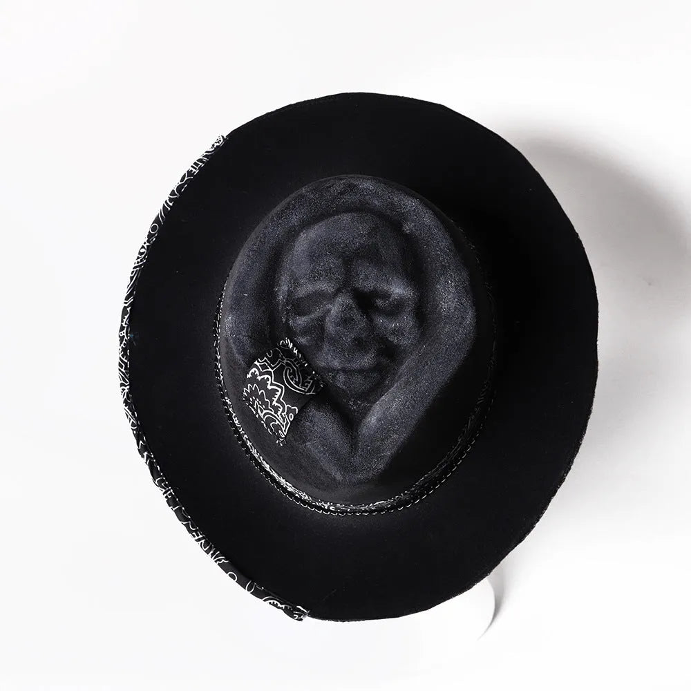 Handmade black wool felt skull hat with conical crown and blue denim accent band, shown from the side.