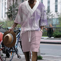 Man wearing a printed drop-shoulder knitted short-sleeve top with matching shorts.