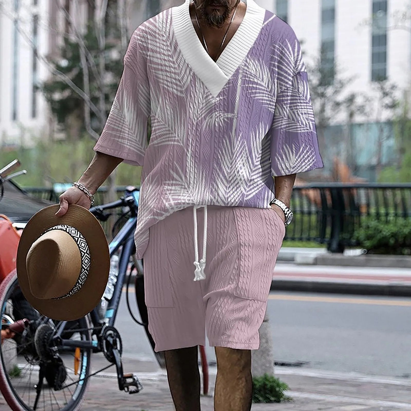 Man wearing a printed drop-shoulder knitted short-sleeve top with matching shorts.
