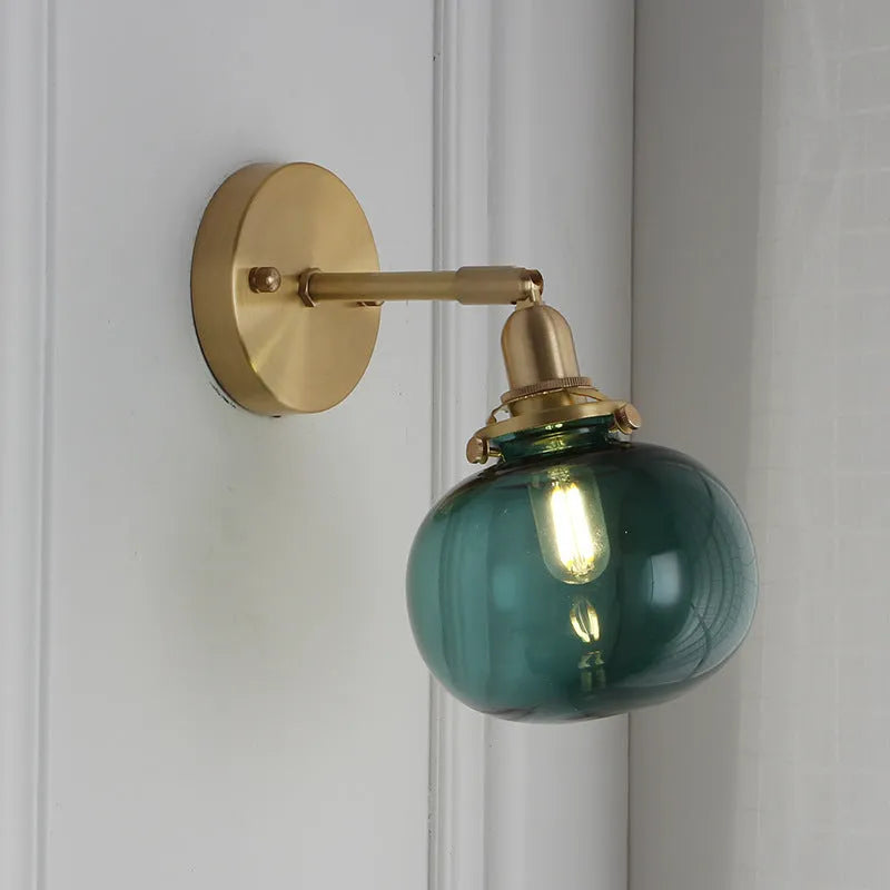 Creative pumpkin-shaped wall lamp with a textured glass shade mounted on a white wall.