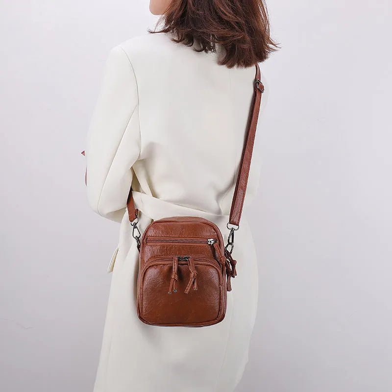 Soft PU leather mini shoulder bag with chain detail in black and brown colour options
