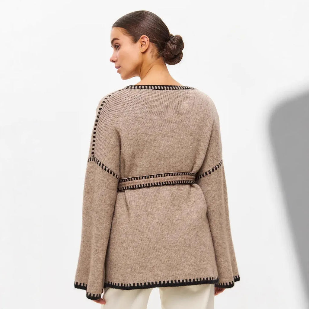 Loose lace-up knitted cardigan in camel colour, showing mid-length fit and long sleeves.