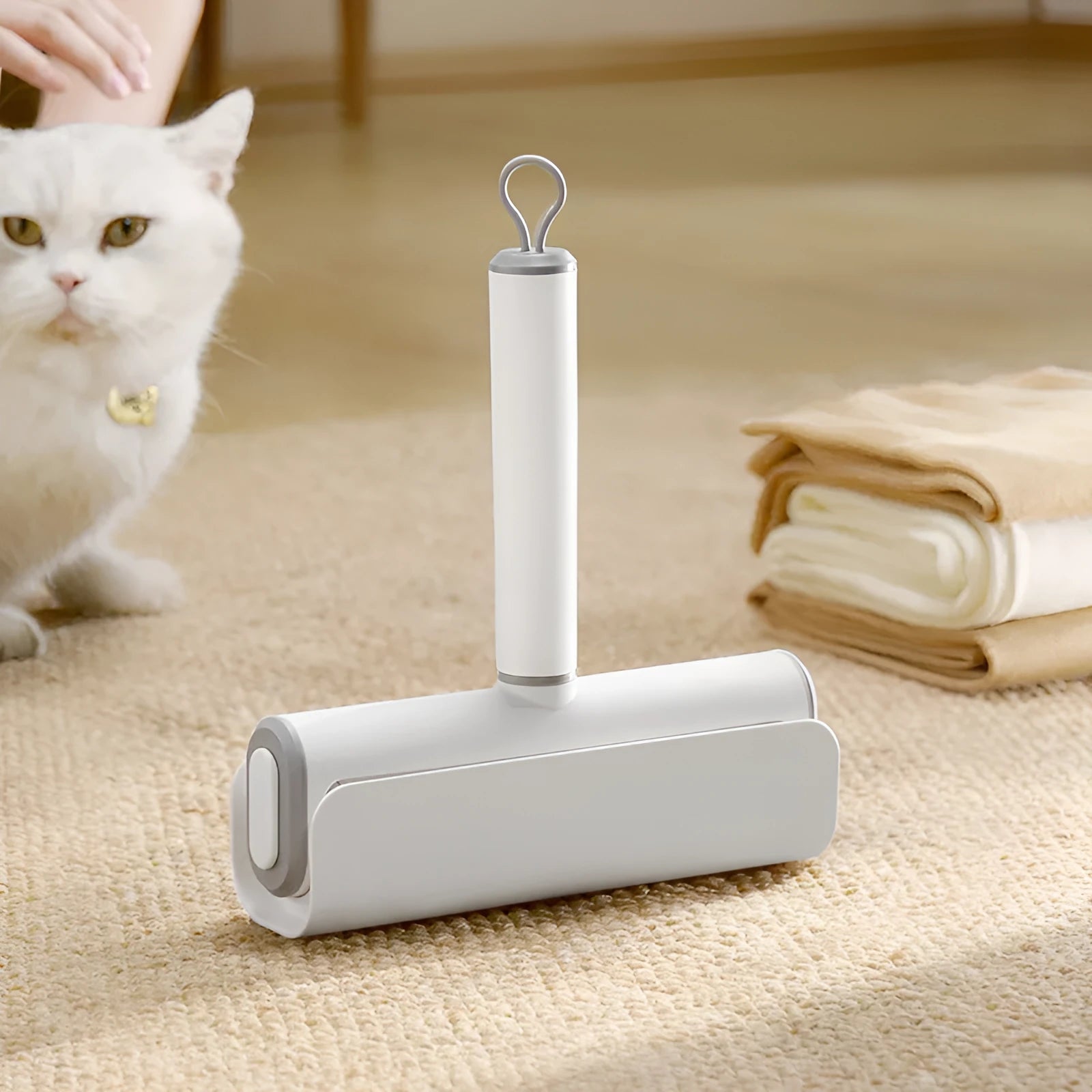Handheld lint remover roller with tearable paper stick for removing pet hair from floors and furniture