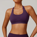 Close-up side view of a black halter neck sports bra for women, showing the strap detail and smooth nylon fabric.