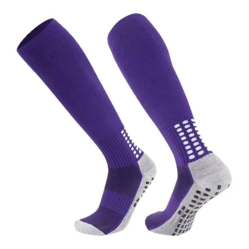 Solid colour polyester football socks in long tube style with multiple colour options including black, white, red, and green.